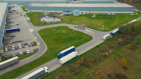 warehouses, huge logistics center near the highway, view of a large number of cargo trailers and containers, international cargo transportation, aerial view