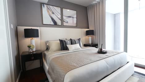 dormitorio amueblado con ropa de cama elegante, sofá y muebles de iluminación