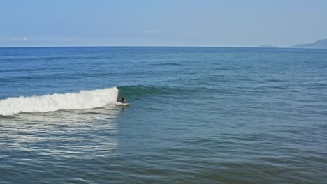 Aerial:-surfer-catching-perfect-paradise-wave-and-doing-roundhouse-cutback