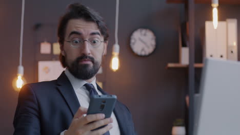 businessman checking mobile phone in office