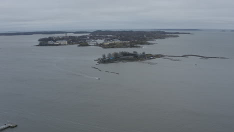 drone view of floating boat in the sea near small islands