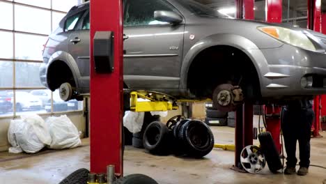 car lifted for service in an auto repair shop