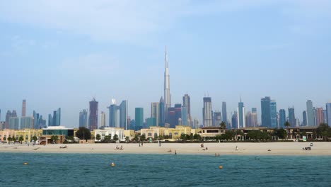 Smooth-pull-out-shot-of-the-Dubai-skyline-and-beaches-on-a-beautiful-sunny-day