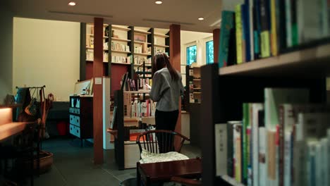 woman browsing books in a cozy bookstore