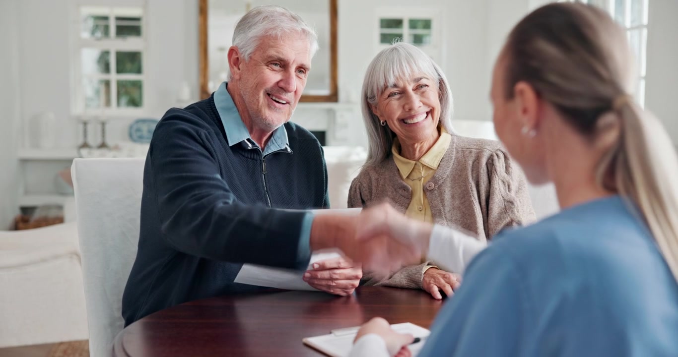 Senior Couple Shaking Hands with Professional Advisor