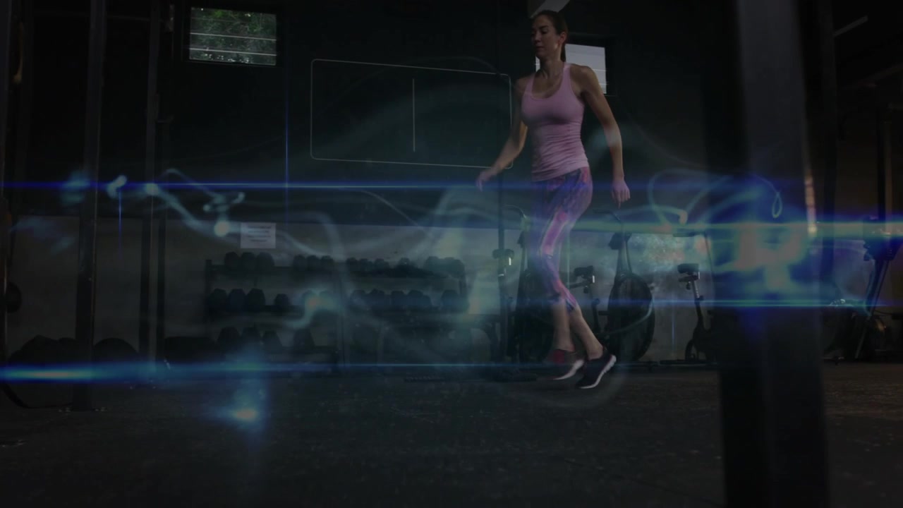 Woman rising from crouch, doing lateral steps in gym for fitness with blue smoke and lens-flares