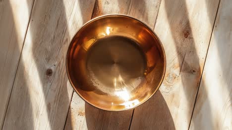 golden singing bowl on a wooden background