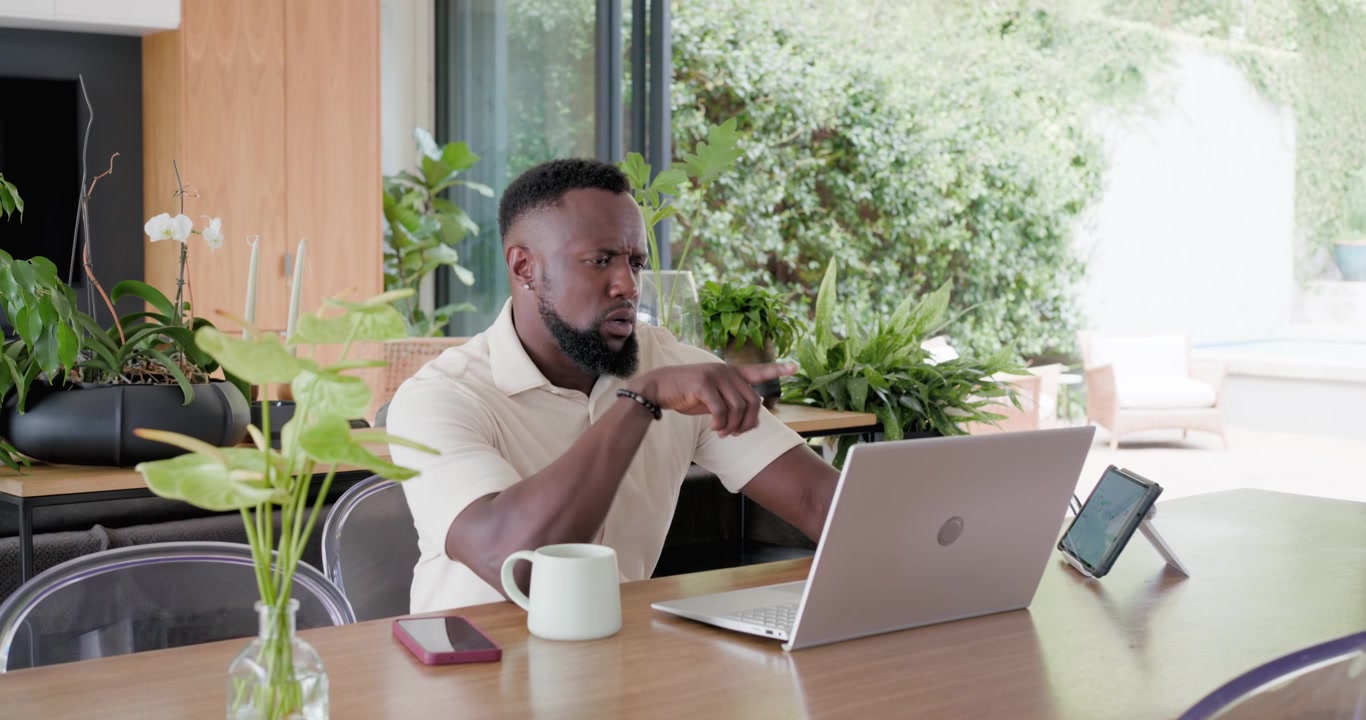 Getting notification, man walking to table, placing tablet, mug and laptop, typing for work