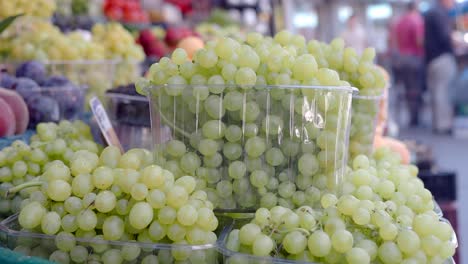 a close-up view of fresh green grapes in a market