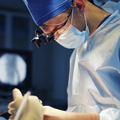 neurosurgeons doing operation. professional surgeons in medical masks working with surgical tools during operating process. close-up.