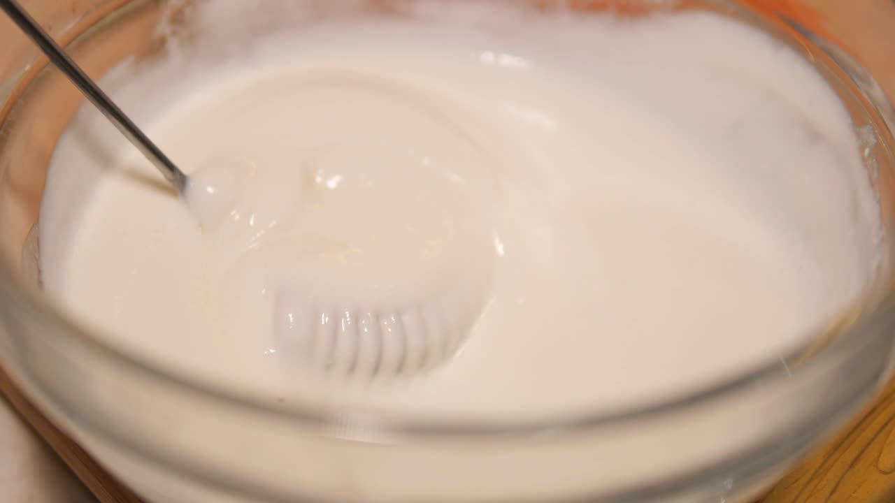 Mixing Whipped Cream in a Glass Bowl