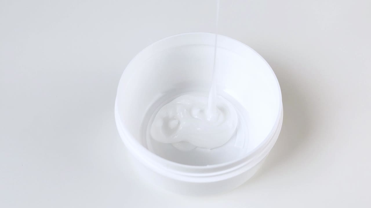 크림은 플라스틱 둥근 항아리에 부어집니다.