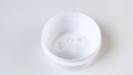 cream is poured into plastic round jar