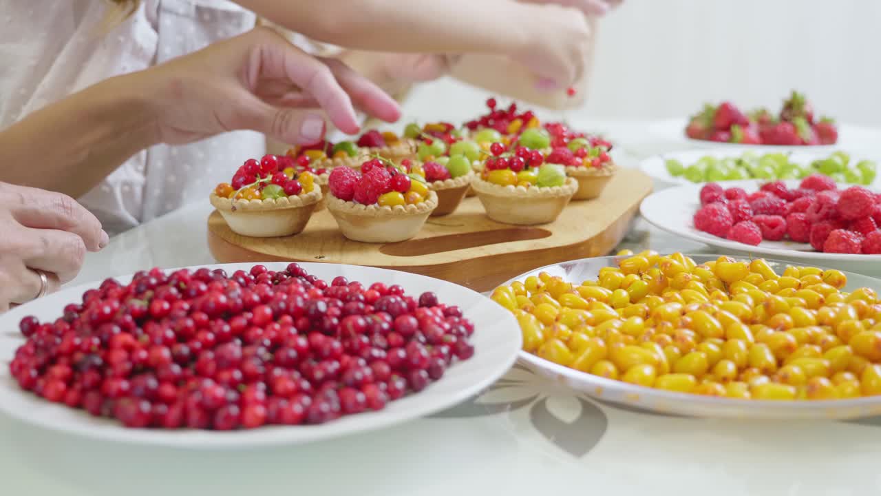 Family making fruit tarts