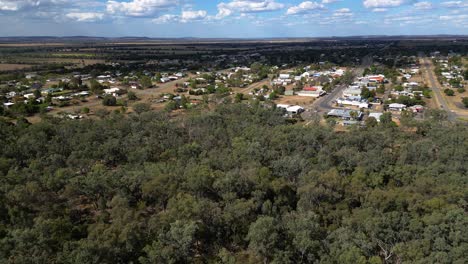 right to left aerial views over the town of taroom and surrounding bushland, central queensland, australia.