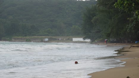 dam trau beach and waves rolling into seashore on a cloudy day in con dao, vietnam