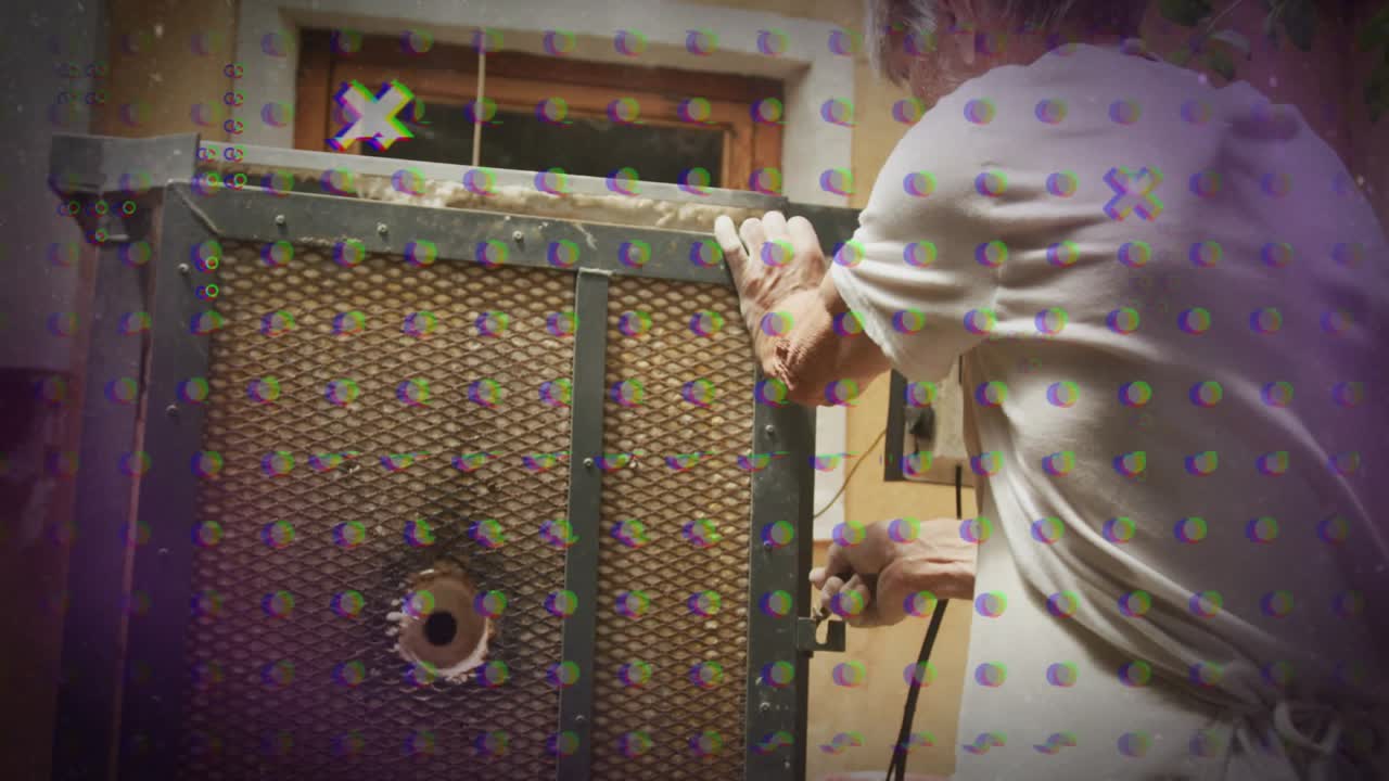 Workshop technician grabbing latch, twisting latch and releasing mesh panel for interior access