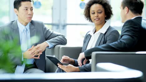 multi ethnic business team meeting using wireless tablet