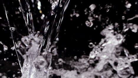 Water-Splashing-into-black-background-in-slow-motion-with-wet-liquid-240p