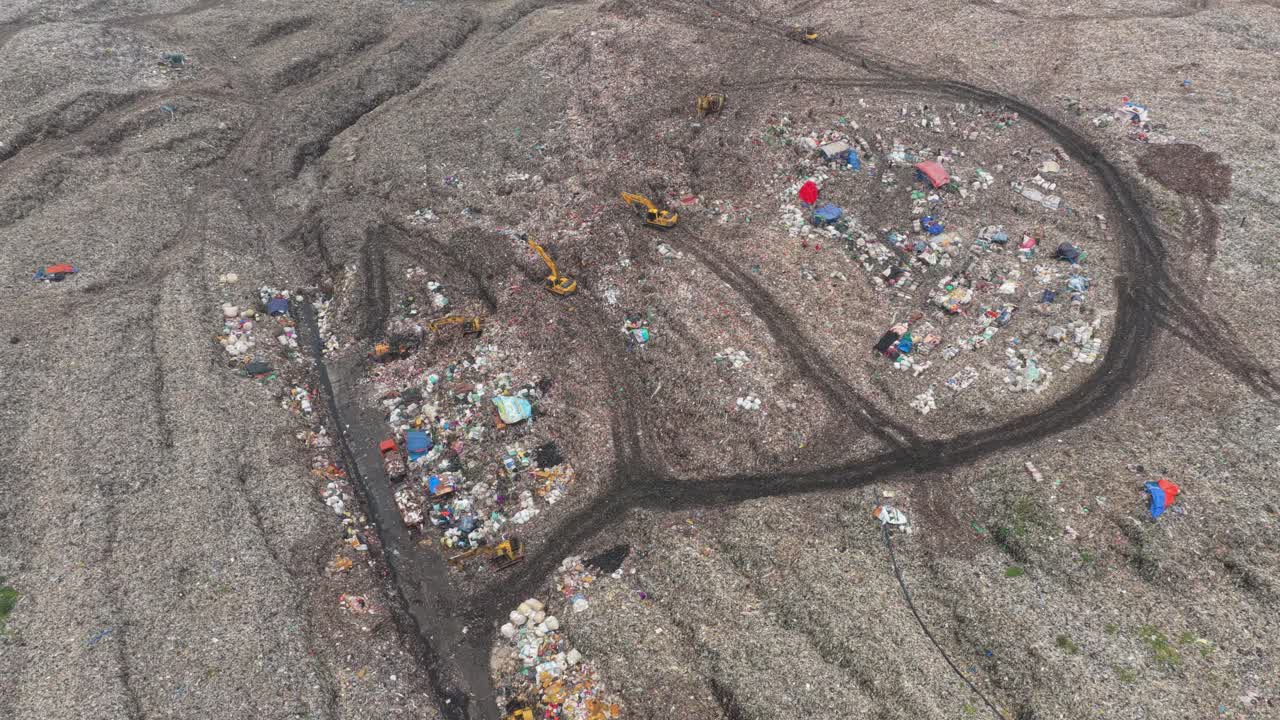 Excavators working in the bantar gebang landfill near jakarta