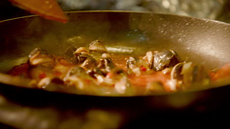 handheld - the snails frying in a delicious tomato sauce