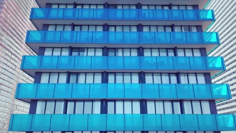 shot of reflections of sun, clouds and sky on glass windows of city skyscraper.