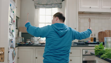 happy-teenage-boy-with-down-syndrome-dancing-in-kitchen-having-fun-celebrating-funny-dance-enjoying-weekend-at-home