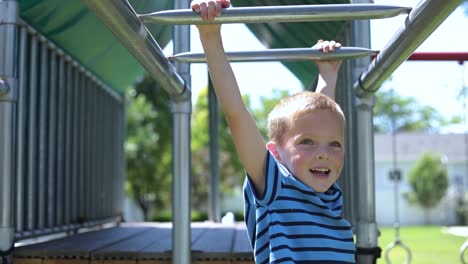 Slow-Motion-shot-of-a-young-boy-playing-on-the-monkey-bars-on-a-playground-set-in-his-backyard