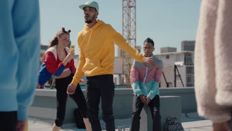 man dancing with friends on rooftop at hip hop dance party performing crazy b boy dance moves with friends cheering