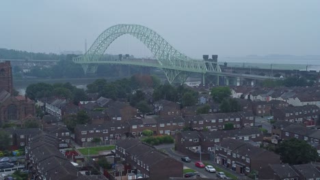 British-Northern-Runcorn-bridge-suburban-residential-townhouse-neighbourhood-aerial-view-rising-left