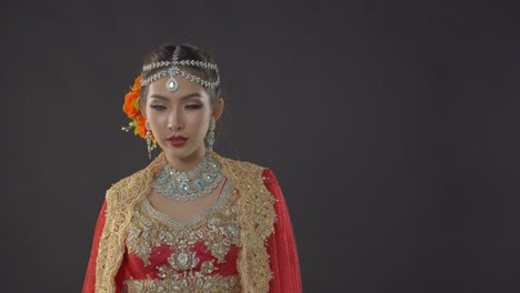 Shy-yet-alluring-Indian-bride-in-traditional-dress-poses-for-her-wedding-portraits