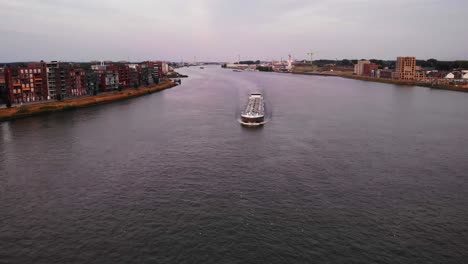 Empty-Container-Ship-cruises-through-Dordrecht,-on-river