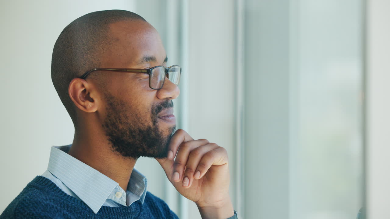 Thoughtful African American Man Looking Out Window