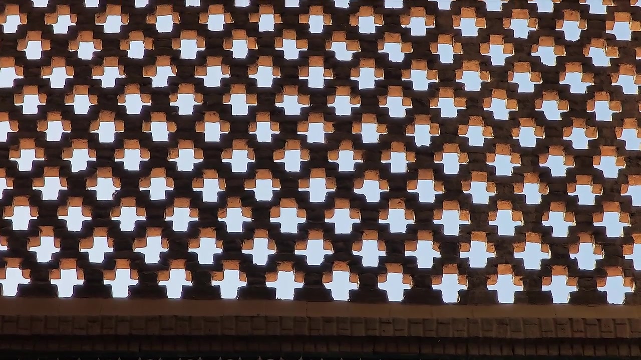 Intricate Islamic Geometric Brickwork and Calligraphy on Historic Architecture