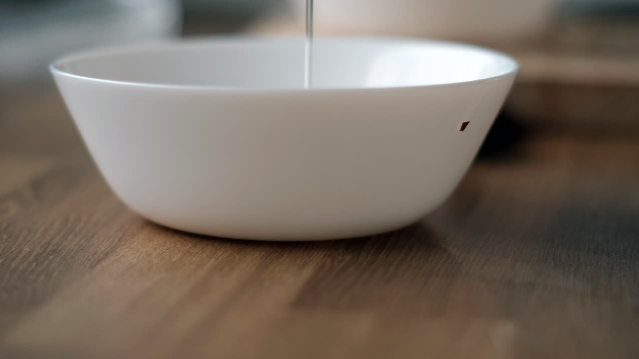 Scrambled Egg Preparation: Close Up of Hands Breaking Two Eggs into White Bowl