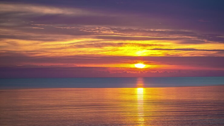 Timelapse of calm oceanside colorful sunset