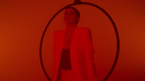 woman performing aerial hoop in a red studio