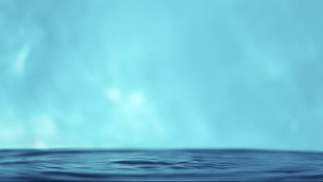 slow motion 4k video of a water surface with falling drops on a blue background. splashing water. studio shooting.