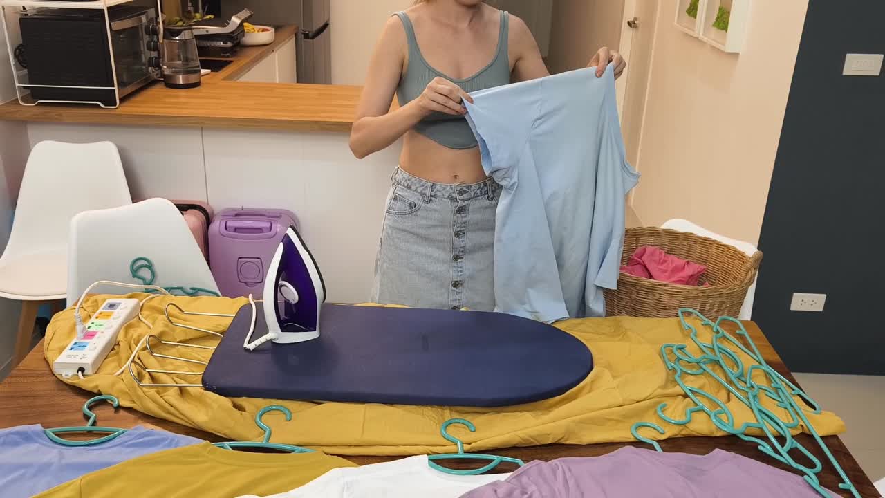 Woman ironing clothes at home