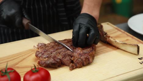 chef cutting a rib-eye steak