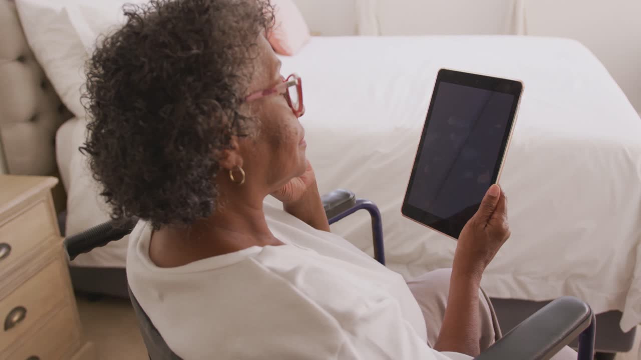 Senior mixed race woman using a digital tablet. Social distancing and self isolation in quarantine