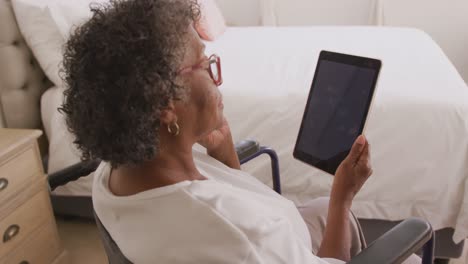 senior mixed race woman using a digital tablet. social distancing and self isolation in quarantine