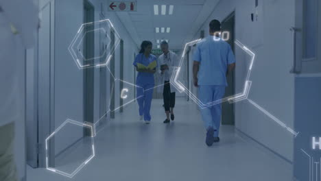 chemical structure animation over medical professionals walking in hospital corridor