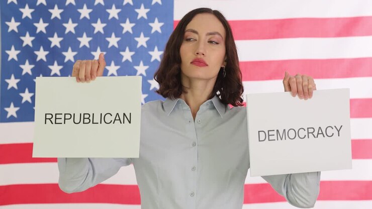 Woman holds signs for 'Republican' and 'Democracy' against an American flag