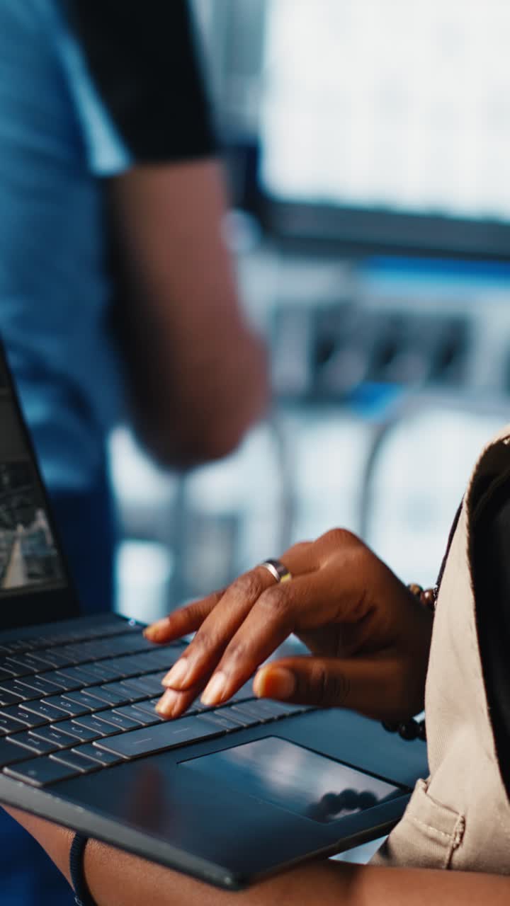 Vertical video Industry 4.0 solar panels plant worker tracking energy production using laptop