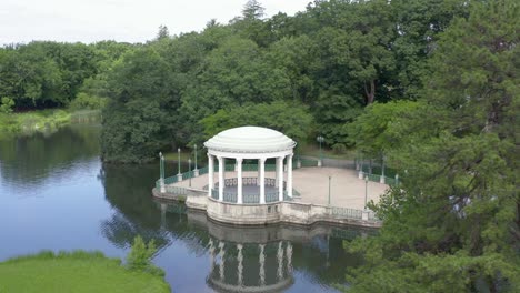 bandstand with reflection on water at roger williams park in providence, rhode island, usa