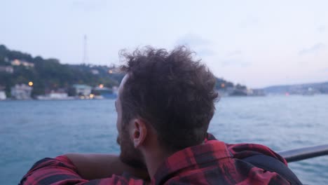 Thoughtful-man-watching-the-city-on-the-ship.