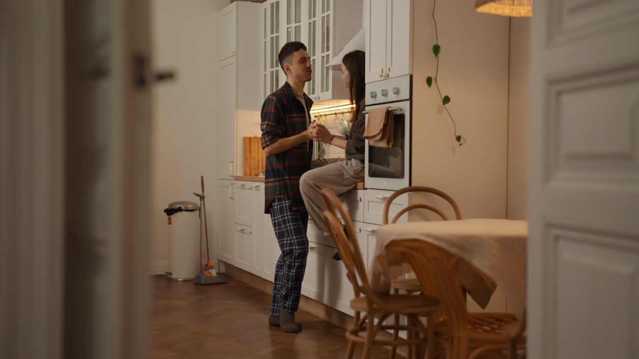 A couple sharing a romantic moment in the kitchen