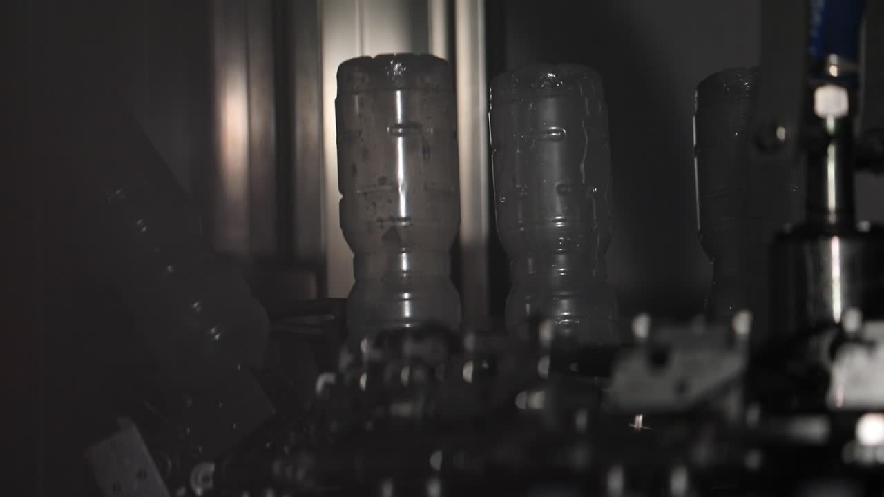 Plastic Bottles Upside Down on a Conveyor Belt Line at a Factory Being Sterilised for Preparation at a Vinegar Factory