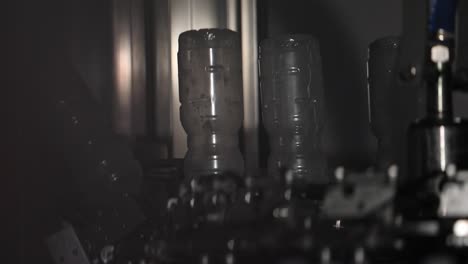 plastic bottles upside down on a conveyor belt line at a factory being sterilised for preparation at a vinegar factory